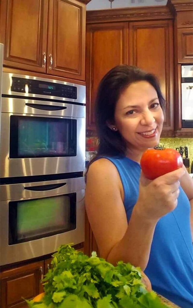 Dr. Karla Arancibia with tomato in hand